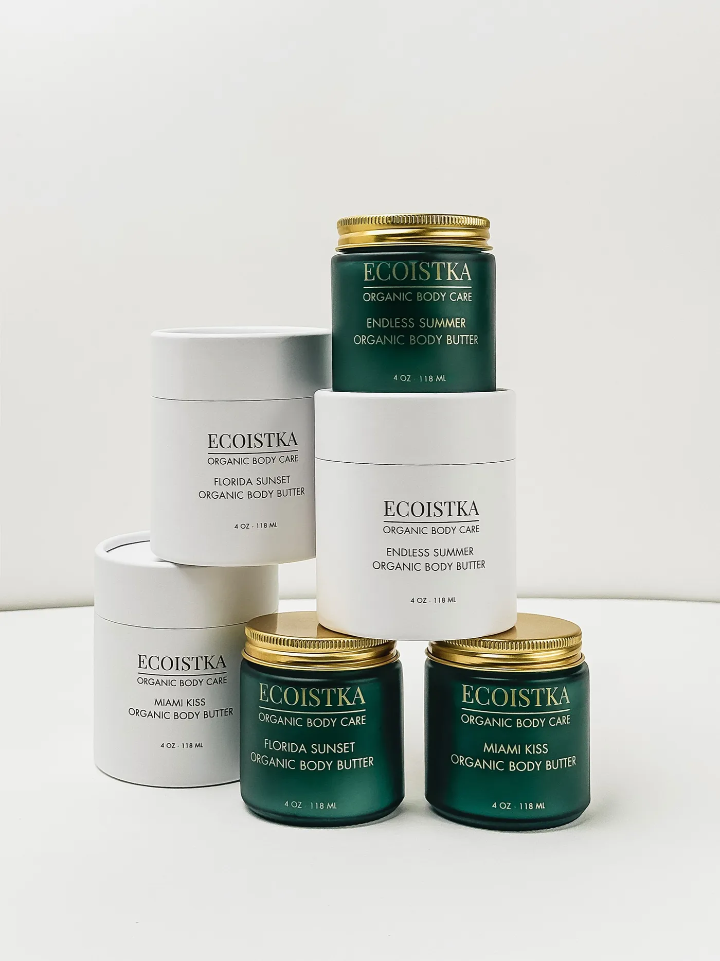 The Ecoistka range: Miami Kiss, Florida Sunset and Endless Summer organic body butters in green glass jars and white tubes